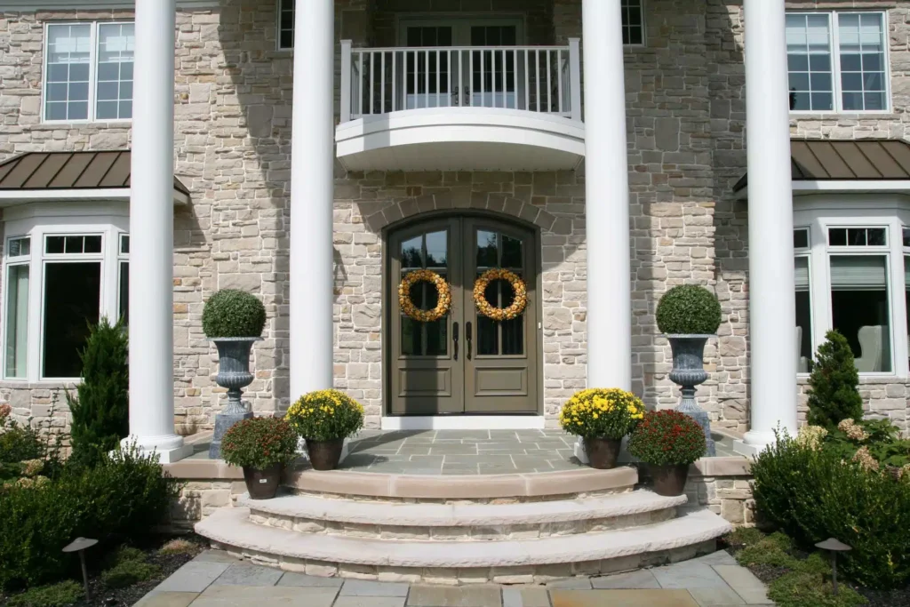 A stone house with a wreath on the front door