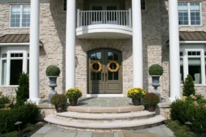 A stone house with a wreath on the front door