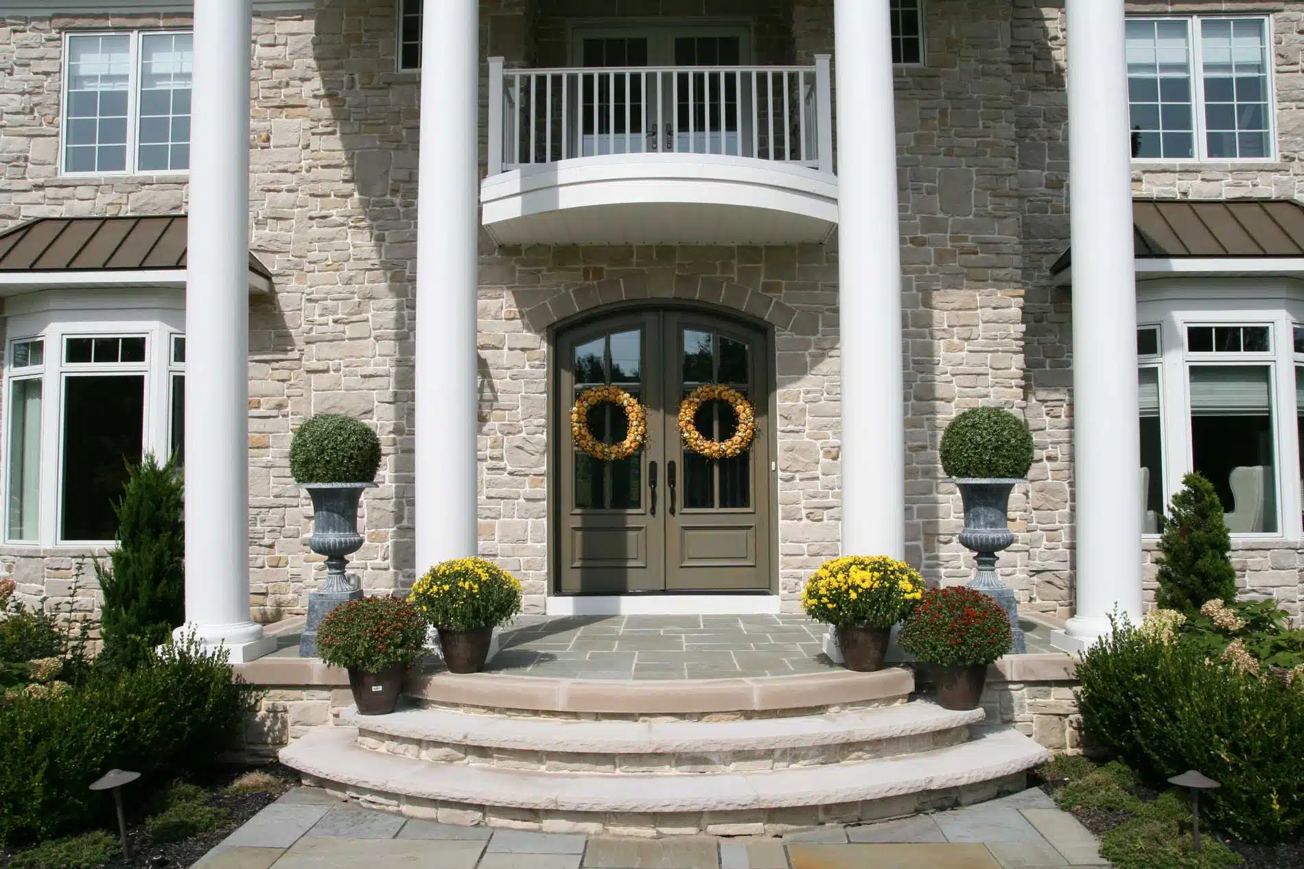 A stone house with a wreath on the front door