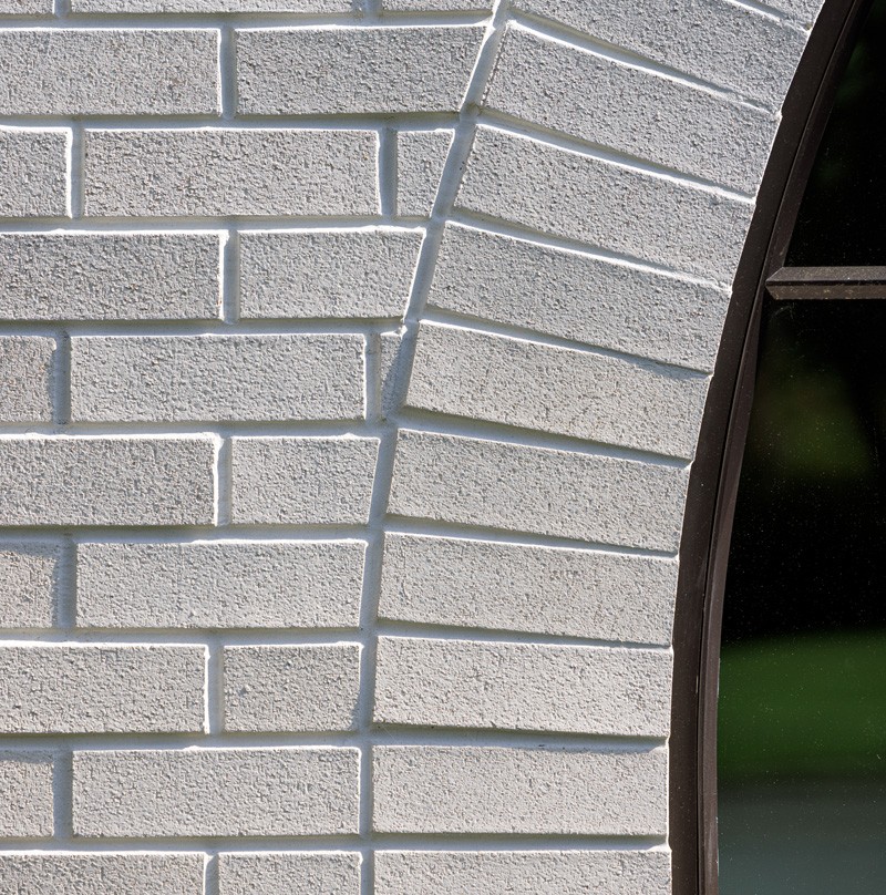 White brick around an arched window opening.